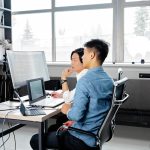 Business team collaborating on software dashboard