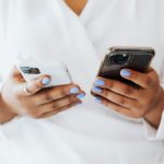 Best Budget vs Premium Smartphones: Is It Worth Spending More in 2026? Person comparing smartphones side by side