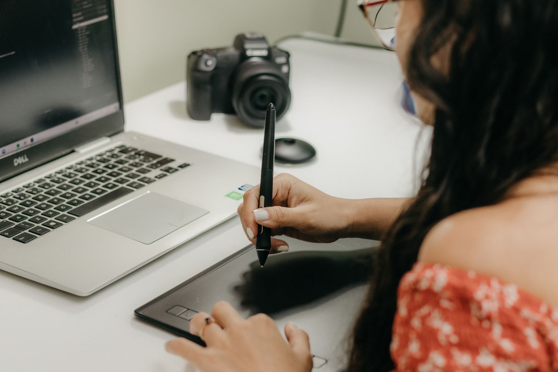 Designer sketching logo concepts on tablet