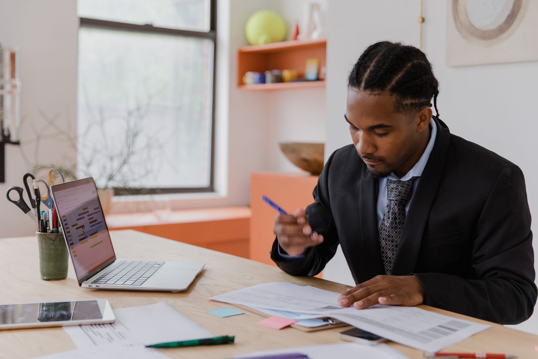 Businesswoman signing contract on tablet in office