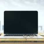 Best Laptops for Work and Gaming in 2026: Top Picks for Every Need Blank laptop on a wooden table with a cup of coffe